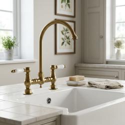 brass-kitchen-faucet-with-white-handles-classic-bridge